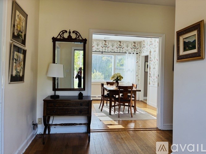 A room with a wooden desk and a mirror.