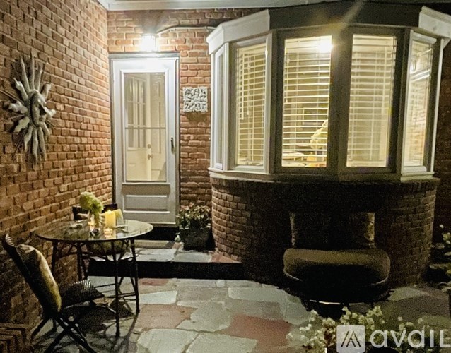 A cozy outdoor patio with a table and chairs.