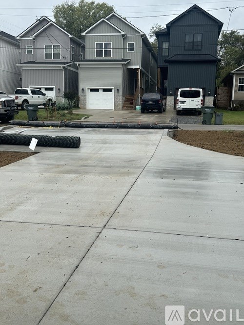 A residential area with houses and parked cars.