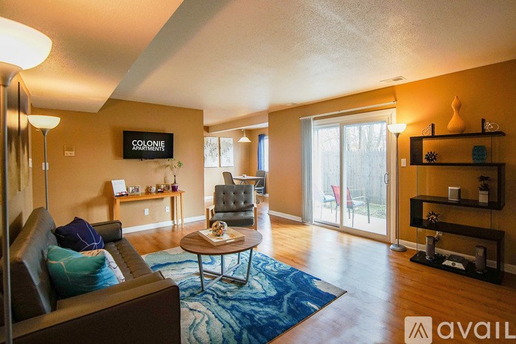 A living room with a couch, chair, and coffee table.