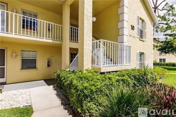 A yellow building with a balcony and a sign that says "available".