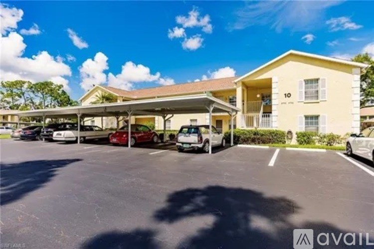 A sunny day at the Avail apartments with cars parked in the lot.