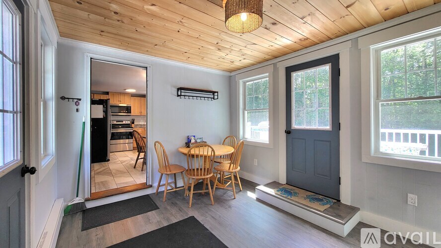 A dining area with a wooden table and chairs.