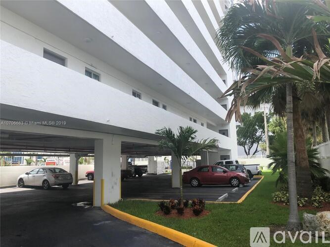 A parking garage with cars parked in it.