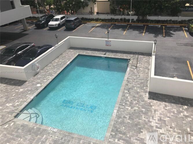 A small pool with a basketball hoop in the middle.