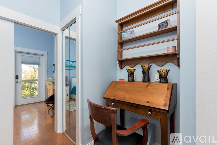 A room with a desk and chair in it.