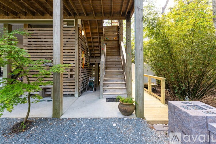 A wooden deck with a staircase leading to a house.