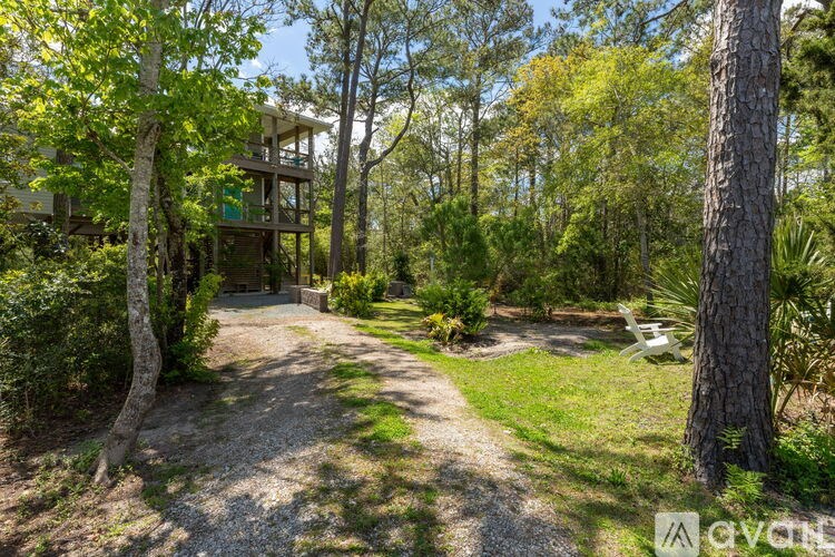 A house is surrounded by trees and greenery.