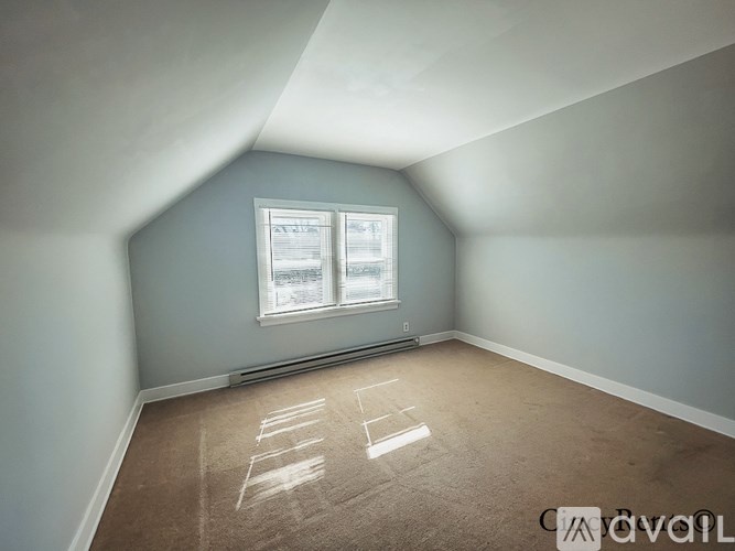 A room with a window and a carpet with the text "AVAILABLE" on it.