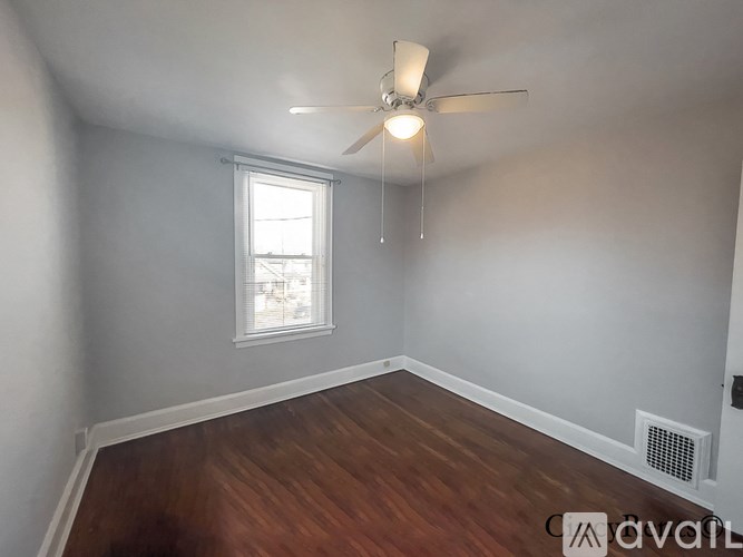 A room with a ceiling fan and a window.