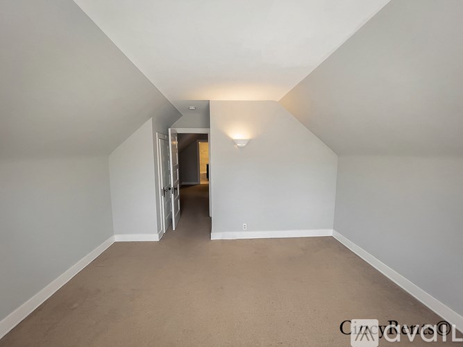 A long hallway with a door at the end.