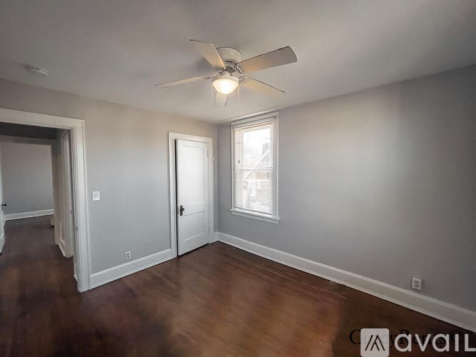 A room with a ceiling fan and a window.