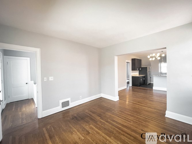 A room with wooden floors and white walls.