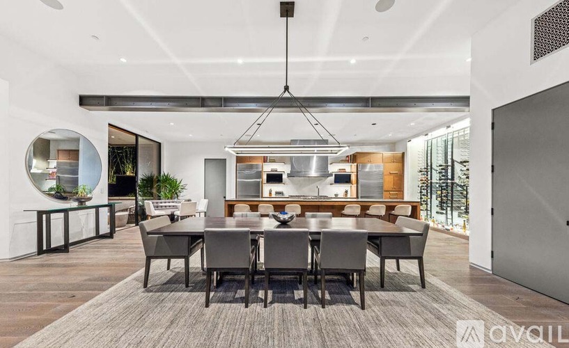 A modern dining room with a large table and chairs.