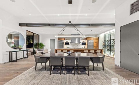 A modern dining room with a large table and chairs.