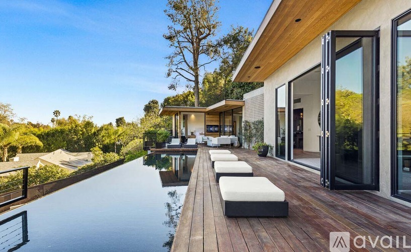 A modern house with a pool in the backyard.