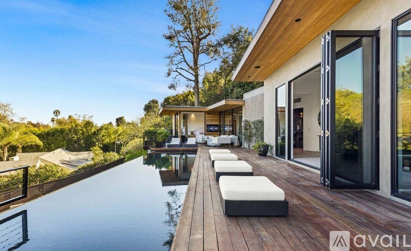 A modern house with a pool in the backyard.