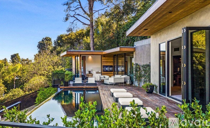 A modern house with a pool in the backyard.