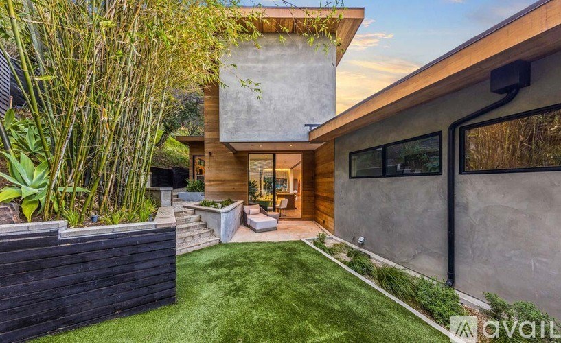 A modern house with a garden in front.