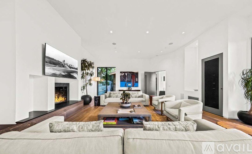 A modern living room with a fireplace and a large couch.