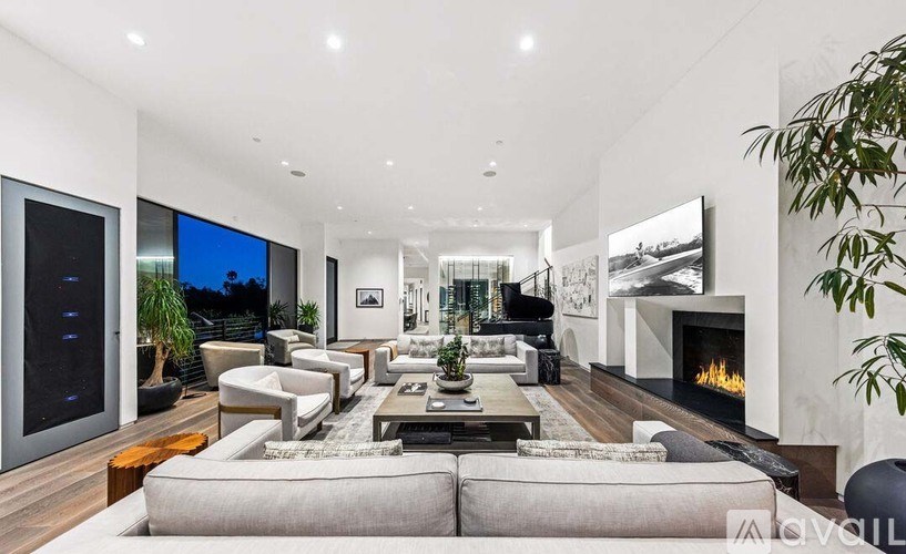 A modern living room with a fireplace and a large screen TV.