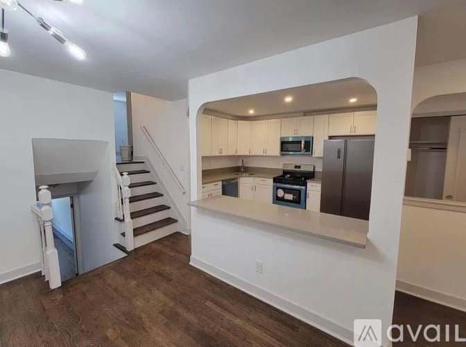 A spacious kitchen with a refrigerator, microwave, and oven is available for rent.