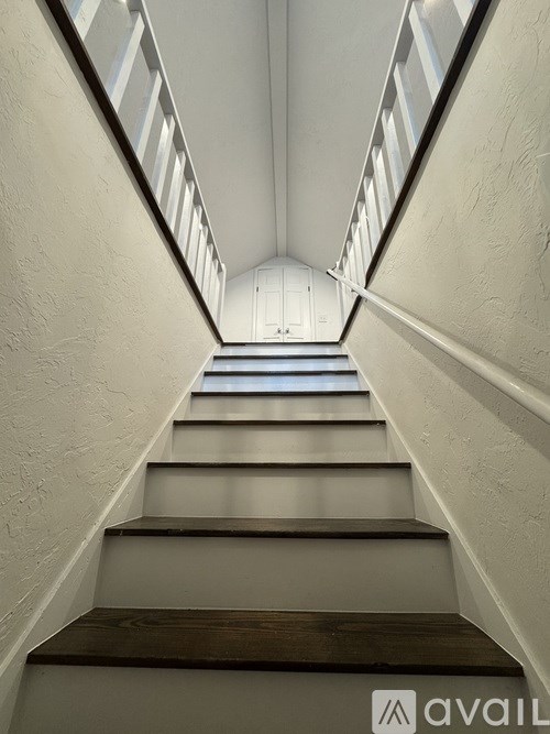 A staircase with a skylight at the top.