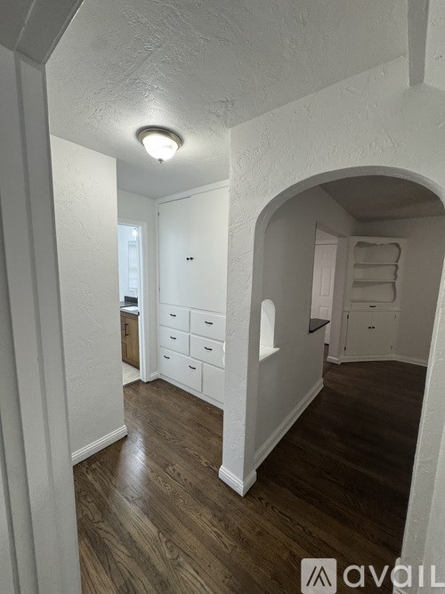 A room with wooden floors and white walls.