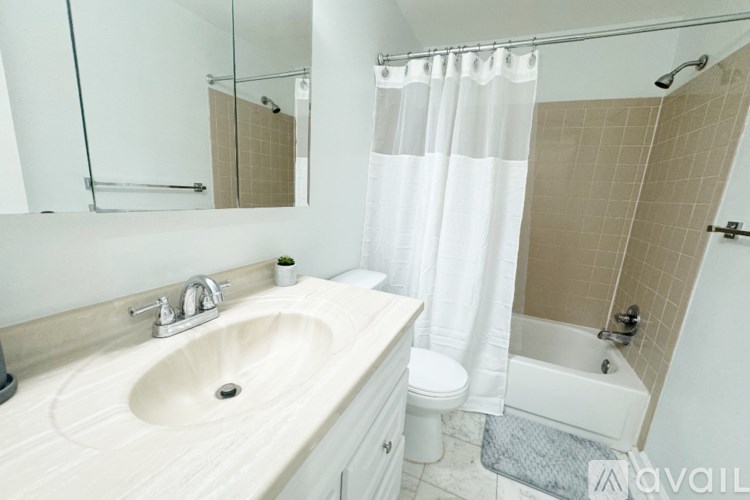 A bathroom with a sink, toilet, and bathtub.