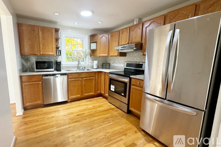 A kitchen with wooden cabinets and stainless steel appliances.