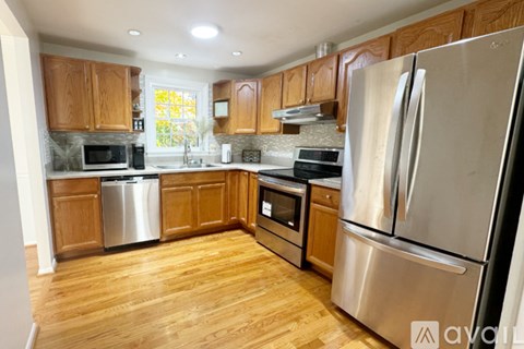 A kitchen with wooden cabinets and stainless steel appliances.