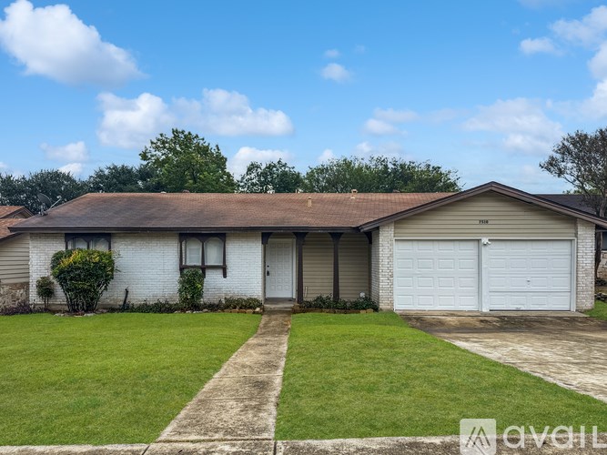 A two-story house with a garage and a driveway.