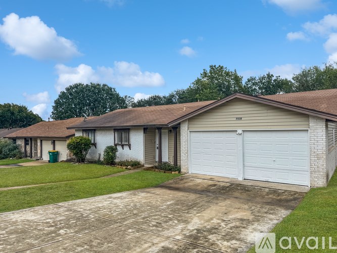 A house with a white garage door is for sale.