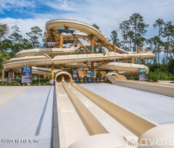 A large water slide with a person standing at the top.