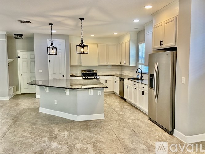 A kitchen with a large island in the middle.