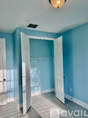 A room with blue walls and a white door.