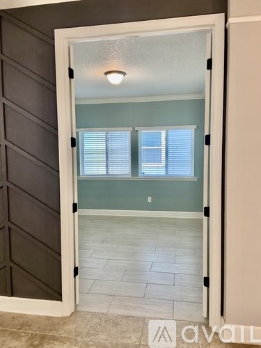 A room with a sliding door and a tiled floor.