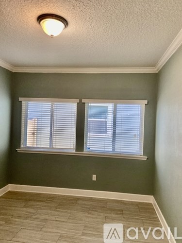 A room with a window and a tiled floor.