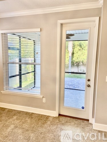 A white door with a glass window is open.