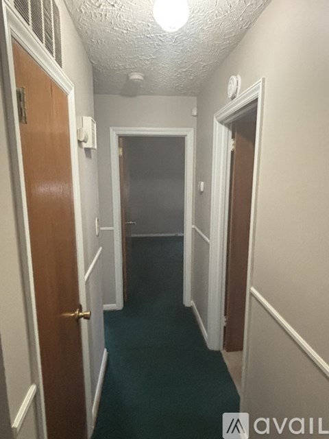 A long hallway with doors on both sides.