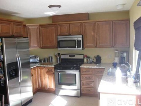 A kitchen with wooden cabinets and stainless steel appliances.