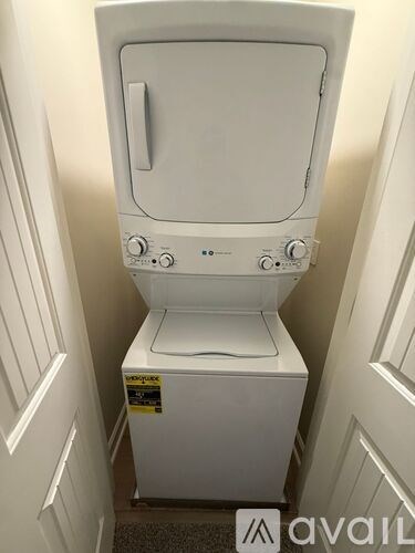 A white toilet with a tank and a sticker on the side.