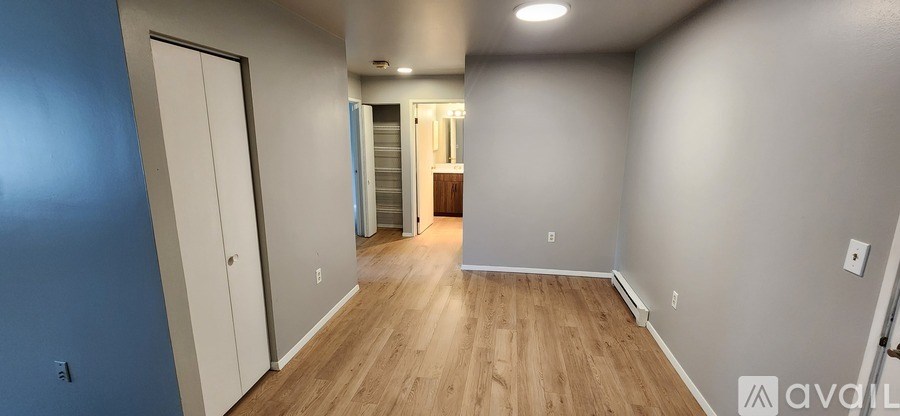 A long hallway with a door on the left and a door on the right.