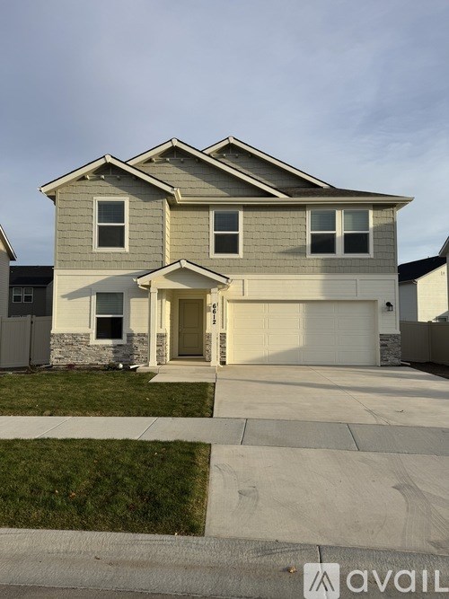 A two-story house with a garage is for sale.