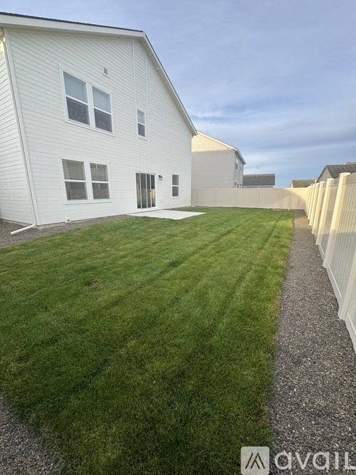 A white house with a gravel path in front.