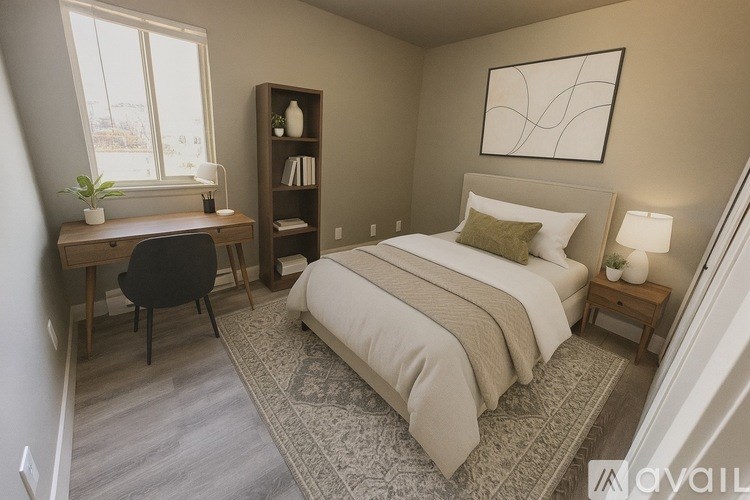 A bedroom with a bed, desk, and chair.