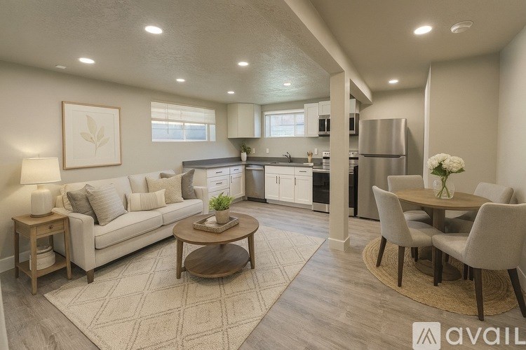 A modern living room with a couch, coffee table, and a dining area.