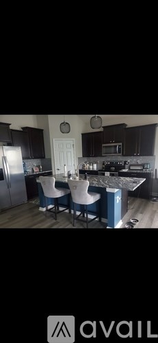A kitchen with dark brown cabinets and a white door.