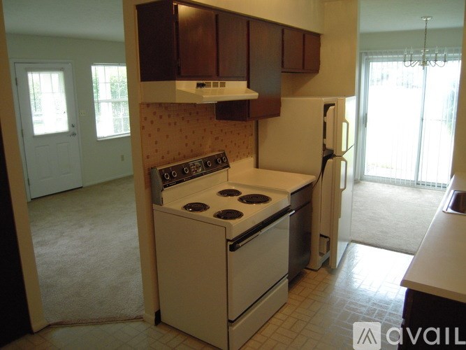 A kitchen with a stove and a refrigerator.