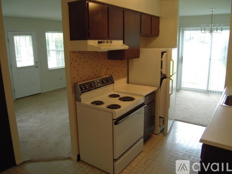 A kitchen with a stove and a refrigerator.
